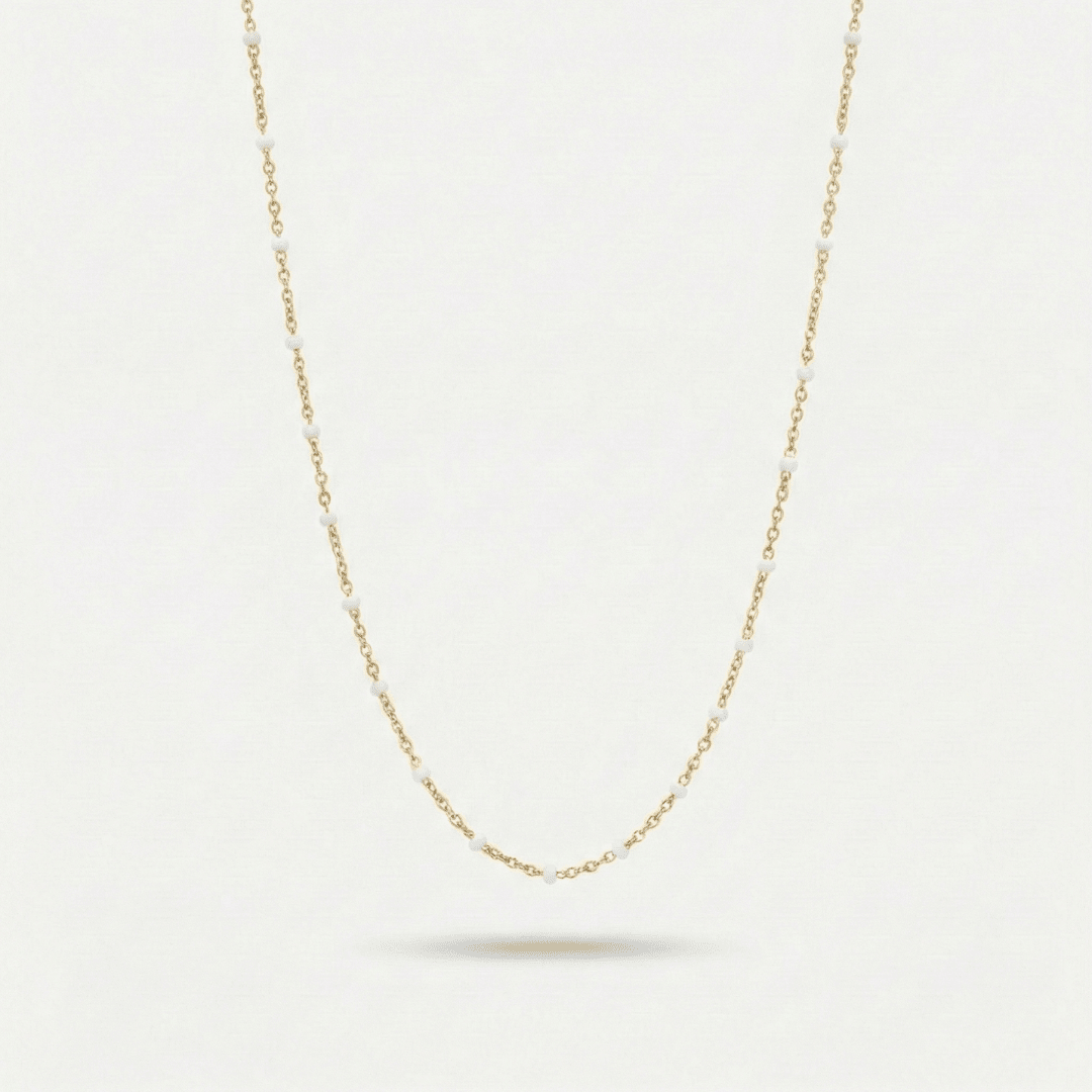 Collar tipo choker dorado con cuentas blancas y eslabones delicados