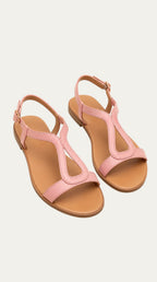 Sandalias planas metalizadas color rosa con tira en T y suela de piel