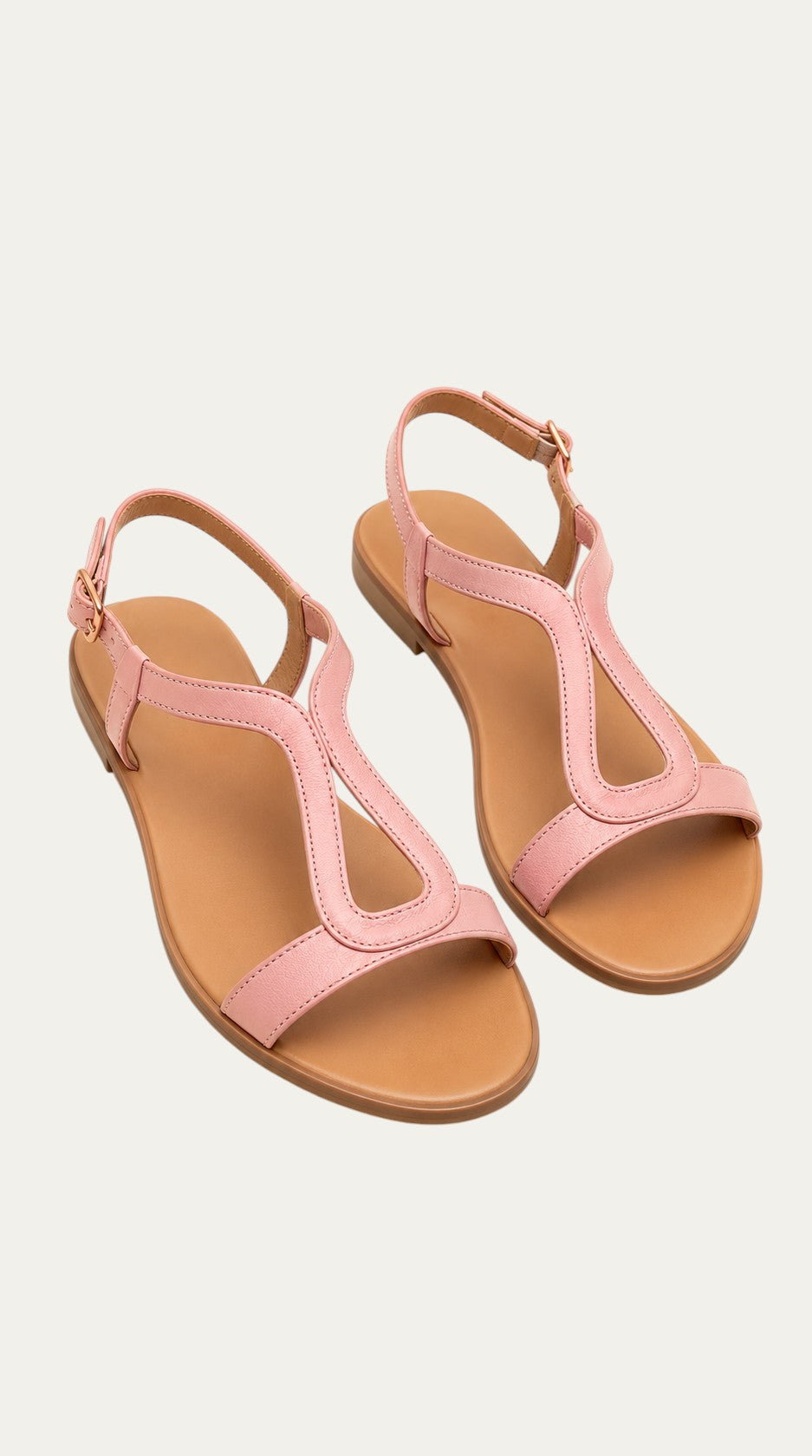 Sandalias planas metalizadas color rosa con tira en T y suela de piel