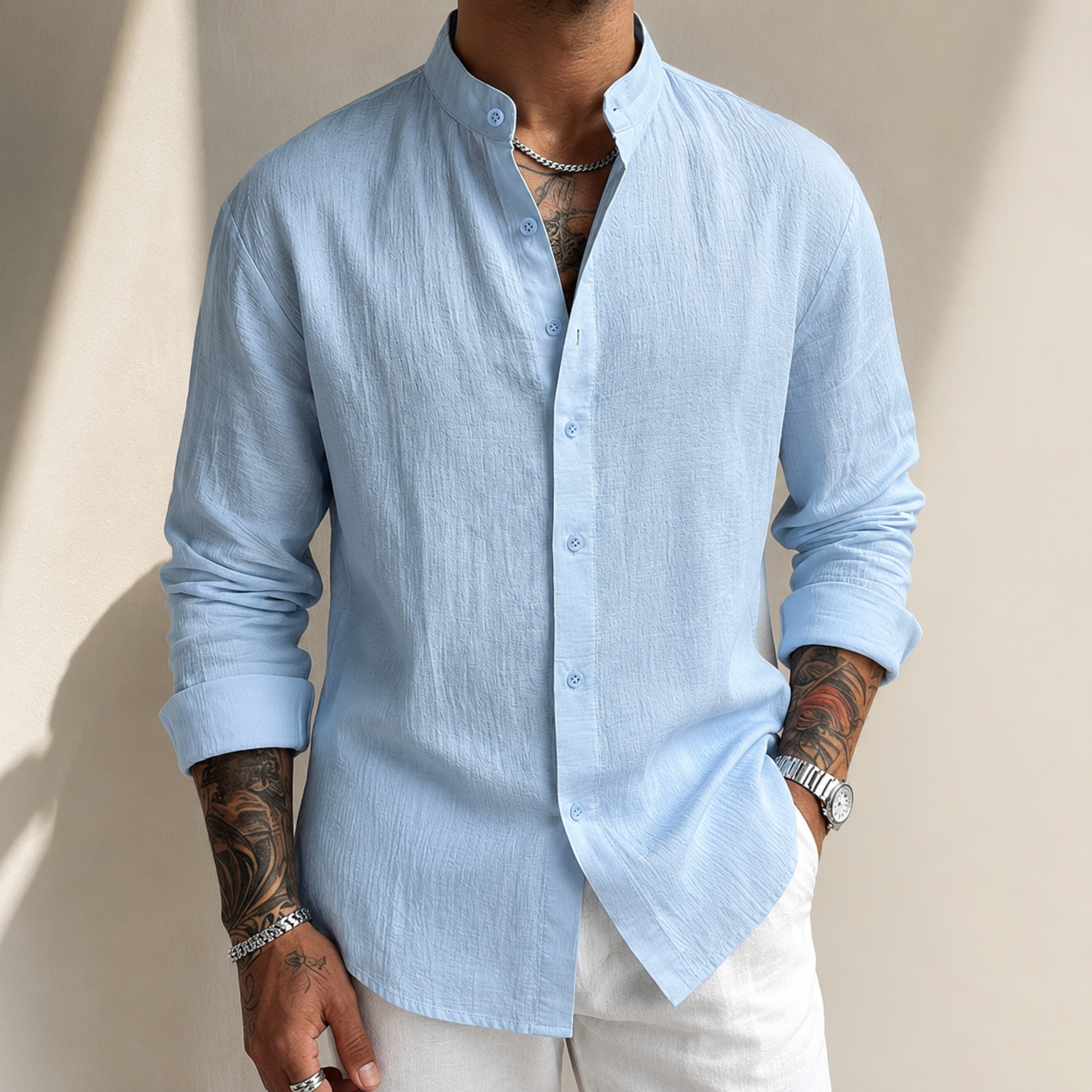 Camisa de lino azul claro con botones al frente y cuello mao, manga larga.