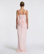 Vestido maxi rosa claro; espalda con tirantes y fruncido con cordones decorativos.