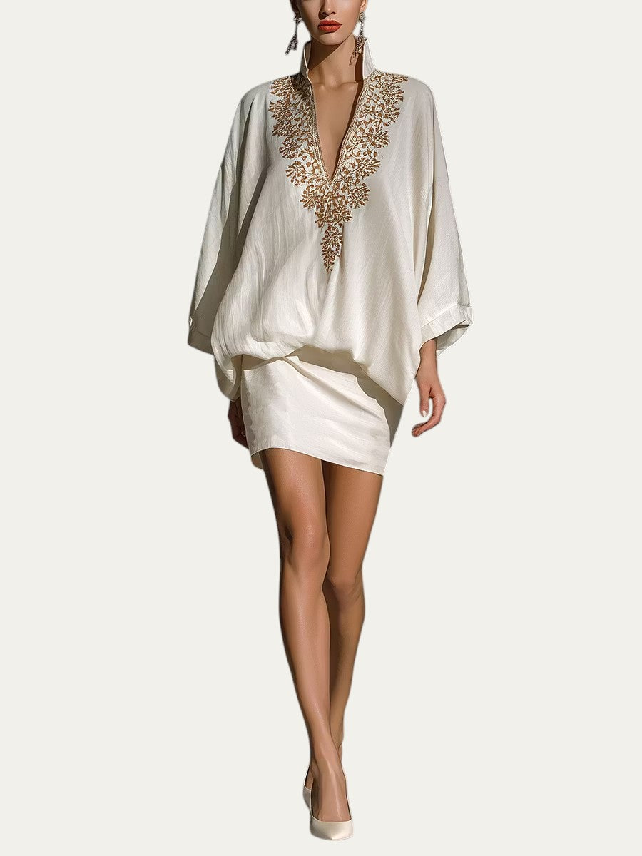 Conjunto de minifalda y blusa blanca holgada con escote V y bordado dorado central